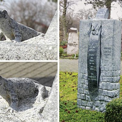 Grabstein, handwerklich bearbeitet,Verde Candayas. Der Grabstein des verstorbenen Betriebsgründers verdeutlicht sein Streben, Zeit seines Lebens zu bauen und zu werken. Dies wird im unteren Teil des Grabmales durch die Gestaltung der Mauer wiedergespiegelt. Seine Seele brach nach dem Ableben aus dem Bauwerk aus zur Reise in die Ewigkeit.